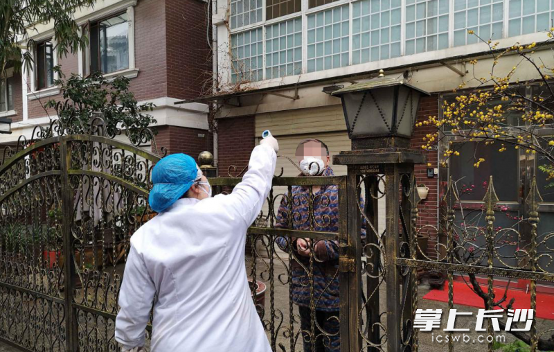 医护人员上门给隔离对象量体温。