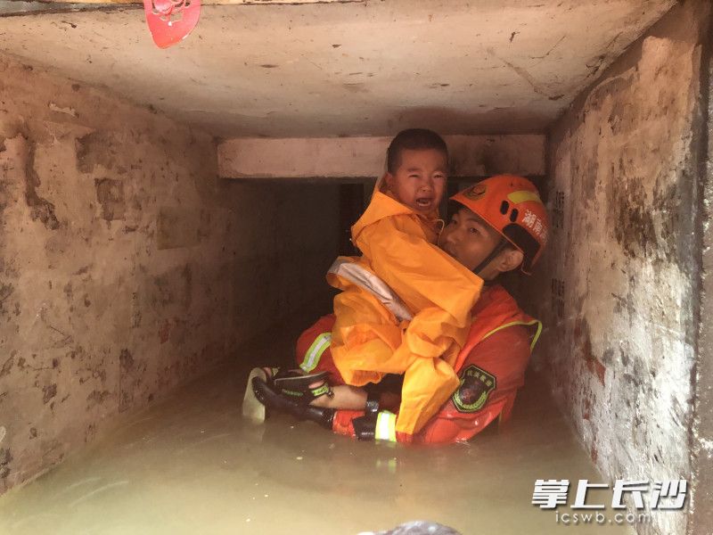 岳阳楼区望月路社区，消防员将一名小朋友转移至安全地带。长沙晚报通讯员 佘家俊 摄