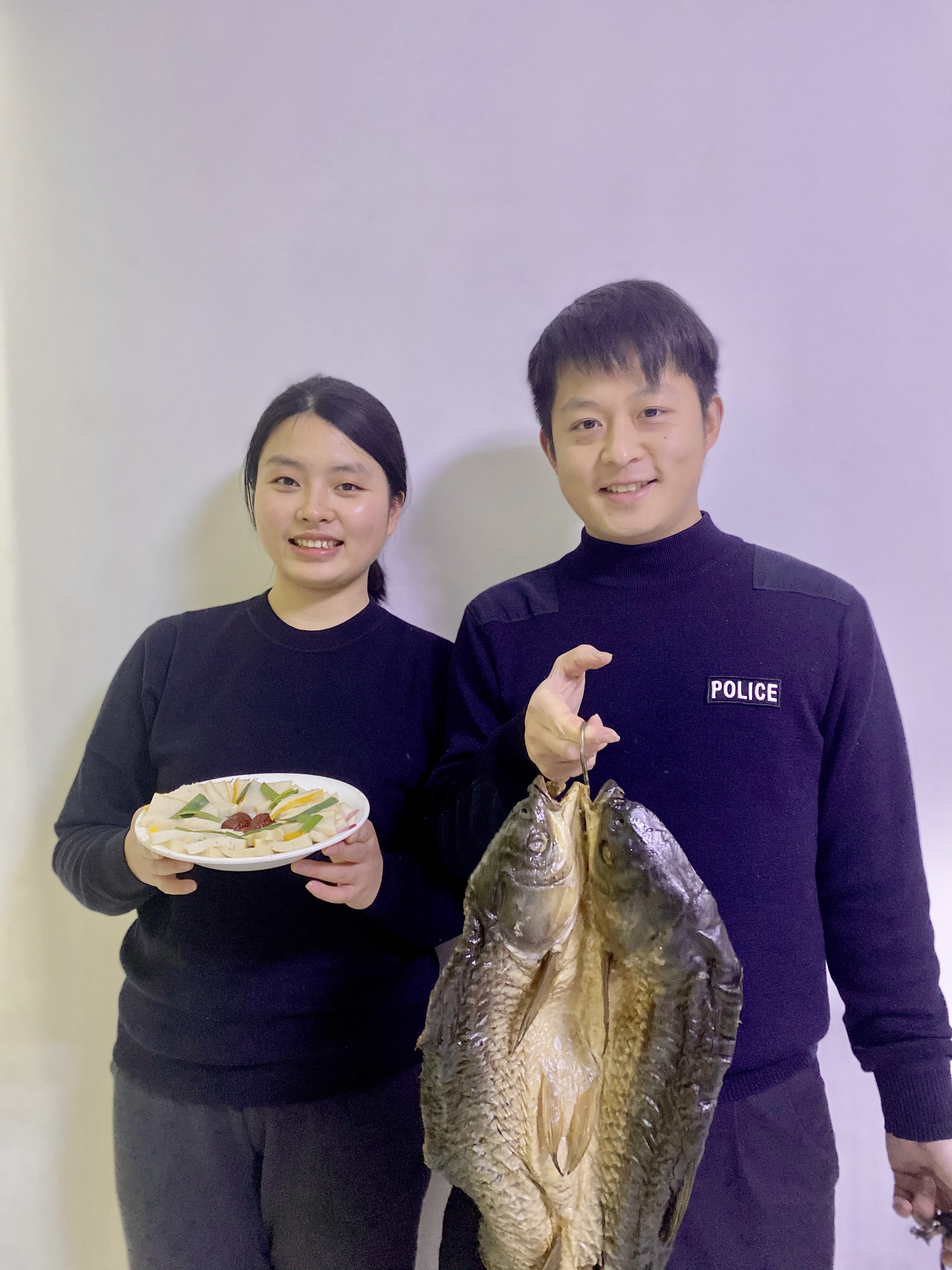 张晨自己在长沙蒸了一份父母寄来的赤壁鱼糕，丈夫陈铖提着寄来的腊鱼。 受访者供图