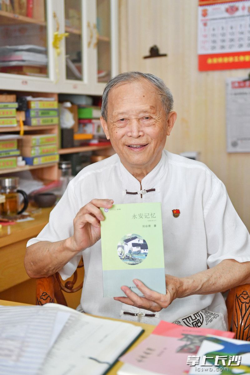 刘谷君和他编写的《永安记忆》。  长沙晚报全媒体记者 王志伟 摄