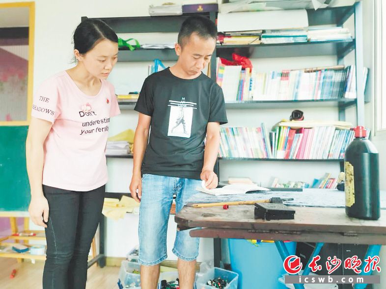 看着“小飞”平时带儿子练习书法的书写台，丈夫暗自神伤。长沙晚报全媒体记者 颜家文 摄