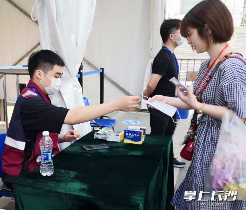 部分观展市民未佩戴口罩，卫健部门工作人员为市民发放一次性医用口罩。开福卫健供图