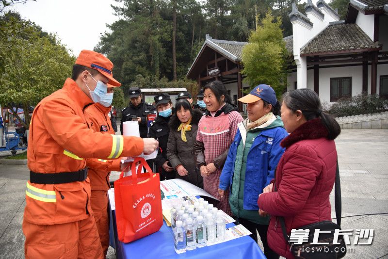 在刘少奇故居，森林消防员向市民游客赠送小礼物，宣传森林防火知识。
